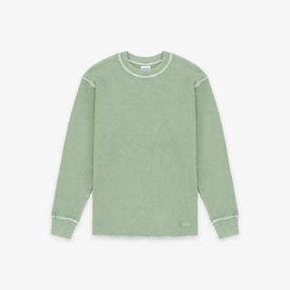 A sage green ribbed knit long-sleeve shirt with contrasting light green trim along the crew neck, shoulders, cuffs, and hem, displayed flat against a light gray background.