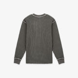 A dark gray ribbed knit long-sleeve shirt with contrasting light gray piping details along the shoulders, cuffs, and collar, shown flat against a light gray background.