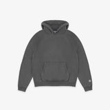 A dark gray washed cotton hoodie with a front kangaroo pocket and a small circular logo on the left sleeve cuff, displayed flat against a light gray background.