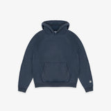A dark navy blue pullover hoodie with a kangaroo pocket and a small circular white logo on the left sleeve cuff, displayed against a clean off-white background.