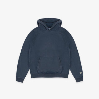 A dark navy blue pullover hoodie with a kangaroo pocket and a small circular white logo on the left sleeve cuff, displayed against a clean off-white background.