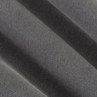 A close-up of dark gray textured fabric with soft diagonal folds showing the woven material detail.