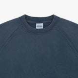 Close-up of a crewneck sweatshirt in a dark slate blue-gray color, showing the inner neck label which reads 'SWEATSHIRTS'.