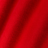A close-up of bright red textured fabric with soft diagonal folds and a plush, nubby surface.