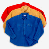Three long-sleeve button-up shirts in red, tan, and royal blue, arranged in a stacked fan layout on a light gray background.
