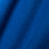 A close-up of textured royal blue fabric with soft folds and a woven or terry-like surface.