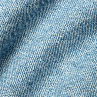 A close-up of light blue denim fabric with a visible twill weave texture and soft folds.