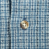 A light blue and white checkered long-sleeve button-down shirt with mother of pearl buttons.