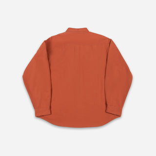 An orange long-sleeve button-down shirt shown from the back, laid flat on a light gray background.