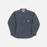 A dark slate blue long-sleeve button-up shirt with two chest pockets, laid flat against a light gray background.