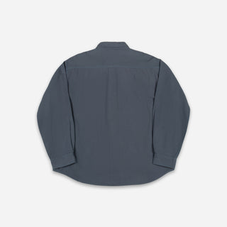 A dark slate blue long-sleeve button-up shirt shown from the back, laid flat against a light gray background.