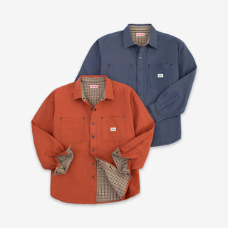 Two long-sleeve button-front work shirts shown on a light gray background, one in rust orange and one in slate blue, both with plaid inner lining and chest pockets.
